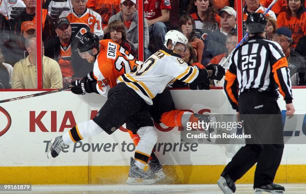 Vladimir Sobotka of the Boston Bruins crushes Matt Carle of the Philadelphia Flyers against the boards in Game Six of the Eastern Conference...