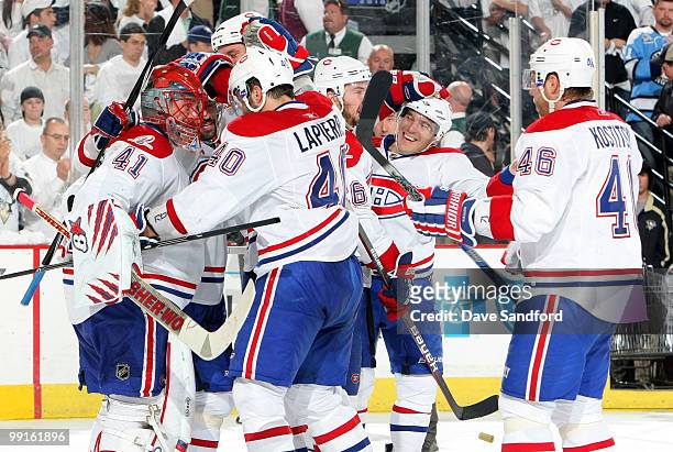 Jaroslav Halak of the Montreal Canadiens is congratulated by teammates after defeating the Pittsburgh Penguins in Game Seven of the Eastern...