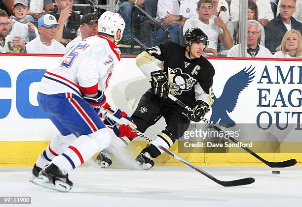 Sidney Crosby of the Pittsburgh Penguins carries the puck as he is defended by Hal Gill of the Montreal Canadiens in Game Seven of the Eastern...