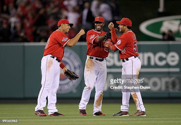 Outfielders Bobby Abreu, Torii Hunter, and Juan Rivera of the Los Angeles Angels of Anaheim celebrate after the game against the New York Yankees on...