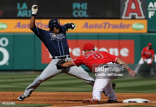 Carl Crawford of the Tampa Bay Rays is nearly picked off by first baseman Kendry Morales of the Los Angeles Angels of Anaheim in the first inning at...