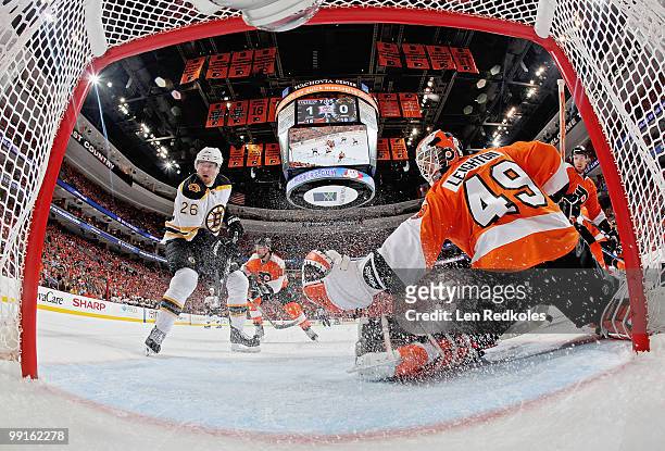 Michael Leighton of the Philadelphia Flyers makes a glove save as Blake Wheeler of the Boston Bruins anticipates a rebound in Game Six of the Eastern...