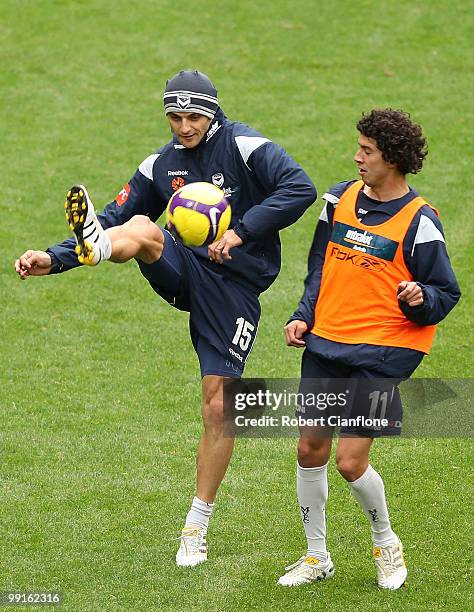 Tom Pondeljak of the Victory gets to the ball ahead of teammate Marvin Angulo during a Melbourne Victory A-League training session at AAMI Park on...