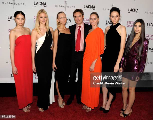 Director Whitney Smith poses with models wearing vintage Halston at the premiere of "Ultrasuede: In Search of Halston" at the Los Angeles County...