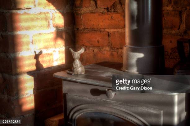 mouse on a wood burning stove - wood mouse stock pictures, royalty-free photos & images