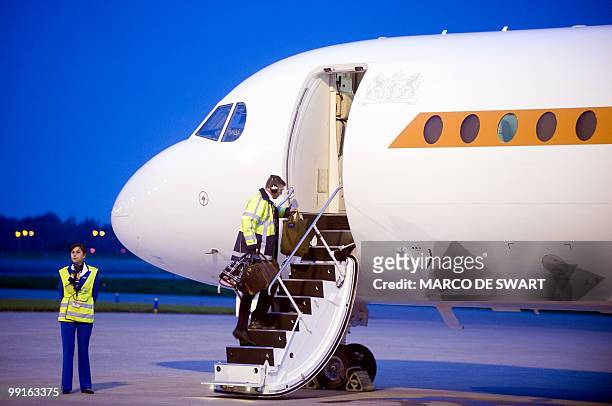 Crew members enter a plane carrying members of the Disaster Identification Team enter at a special plane bound for Libya at Rotterdam Airport on May...