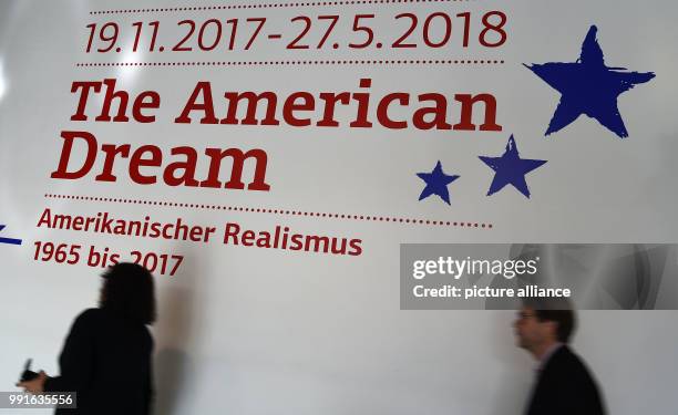 Participants of a press conference pass the logo for the new double exhibition "The American Dream - American Realism from 1965 - 2017" at the Emden...