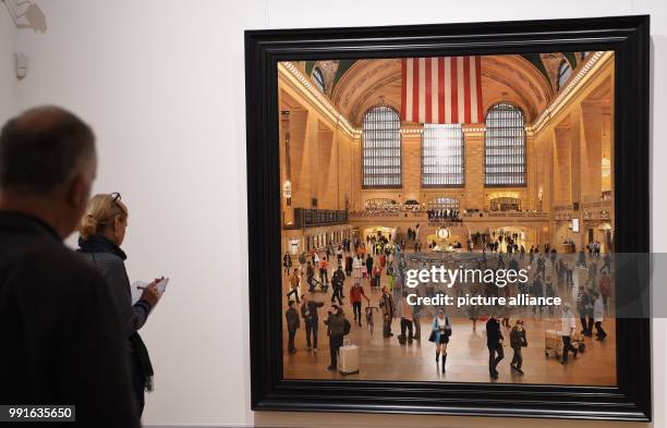 Participants of a press conference look at the work "Grand Central Terminal: An Early December" by S. Roberts from 2009-2012 at the exhibition "The...