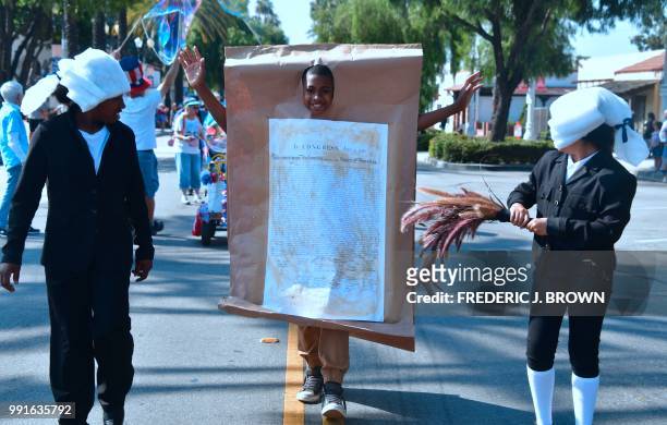 Participant wears the Declaration of Independence during a Fourth of July parade in San Gabriel, California on July 4, 2018 as cities and towns...