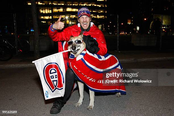 Canadiens fan and his dog celebrate in the streets of downtown Montreal after the Montreal Canadiens defeated the Pittsburgh Penguins in Game Seven...