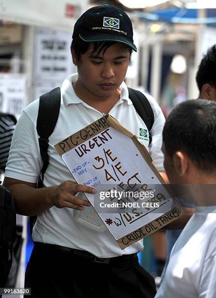 Philippines-Politics-Vote-Economy-Aquino, ANALYSIS by Roberto Coloma A man looks for work at the Seafearer's Centre in Luneta, Manila on May 13,...