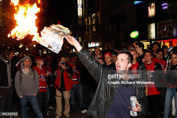 Fan lights paper on fire in the streets of downtown Montreal after the Montreal Canadiens defeated the Pittsburgh Penguins in Game Seven of the...