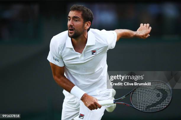 Marin Cilic of Croatia in action against Guido Pella of Argentina during their Men's Singles second round match on day three of the Wimbledon Lawn...