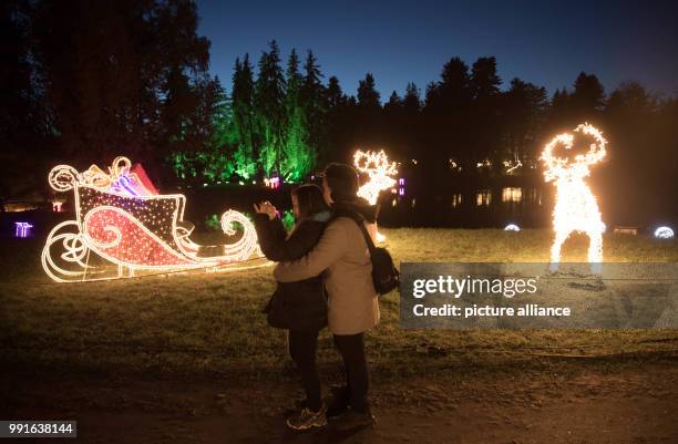 Two visitors at the opening of Christmas Garden at the Botanical Garden in Berlin, Germany, 17 November 2017. A 2-kilometre pathway leads visitors...