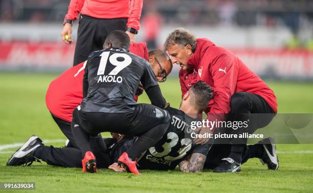 Stuttgart's emergency doctors treat Daniel Ginczek who was injured during the German Bundesliga soccer match between VfB Stuttgart and Borussia...