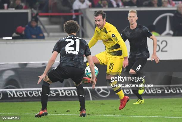 Dortmund's Mario Goetze in action against Stuttgart's Benjamin Pavard and Timo Baumgartl during the German Bundesliga soccer match between VfB...