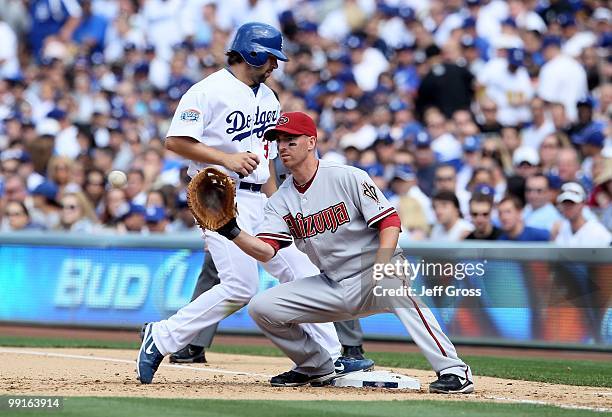 Adam LaRoche of the Arizona Diamondbacks holds Blake DeWitt of the Los Angeles Dodgers on first base at Dodger Stadium on April 13, 2010 in Los...