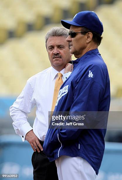 Los Angeles Dodgers' general manager Ned Colletti and manager Joe Torre talk prior to the start of the game against the Arizona Diamondbacks at...
