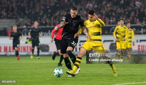 Dortmund's Marc Bartra and Stuttgart's Daniel Ginczek vie for the ball during the German Bundesliga soccer match between VfB Stuttgart and Borussia...