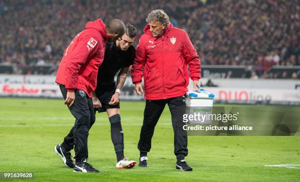 Stuttgart's Daniel Ginczek leaves the pitch after an injury during the German Bundesliga soccer match between VfB Stuttgart and Borussia Dortmund in...