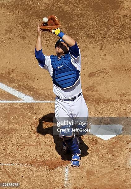 Russell Martin of the Los Angeles Dodgers makes a catch against the Arizona Diamondbacks at Dodger Stadium on April 13, 2010 in Los Angeles,...