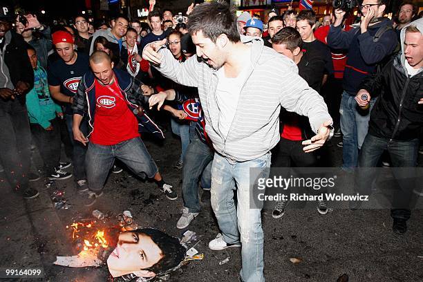 Montreal Canadiens fans burn a picture of Sidney Crosby of the Pittsburgh Penguins in the streets of downtown Montreal after the Montreal Canadiens...