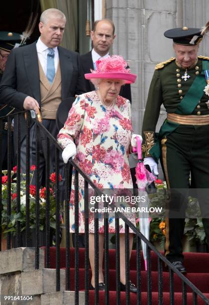 Britain's Queen Elizabeth II, accompanied by Britain's Prince Andrew, Duke of York and Britain's Prince Edward, Earl of Wessex hosts the annual...