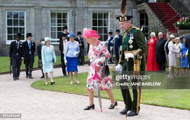 Britain's Queen Elizabeth II hosts the annual garden party at the Palace of Holyroodhouse in Edinburgh on July 4, 2018.