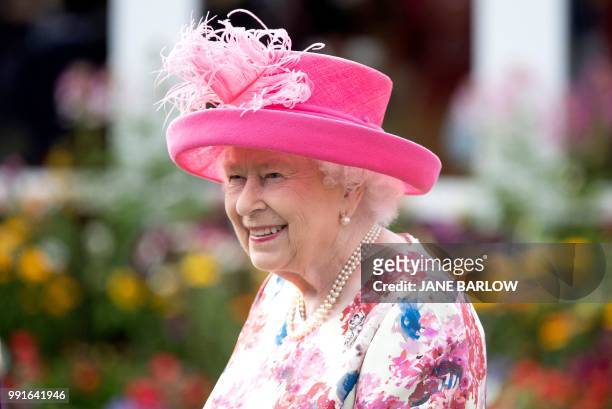 Britain's Queen Elizabeth II hosts the annual garden party at the Palace of Holyroodhouse in Edinburgh on July 4, 2018.