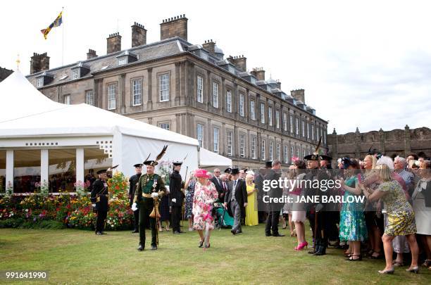 Britain's Queen Elizabeth II hosts the annual garden party at the Palace of Holyroodhouse in Edinburgh on July 4, 2018.