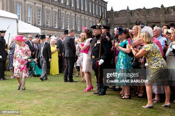 Britain's Queen Elizabeth II hosts the annual garden party at the Palace of Holyroodhouse in Edinburgh on July 4, 2018.