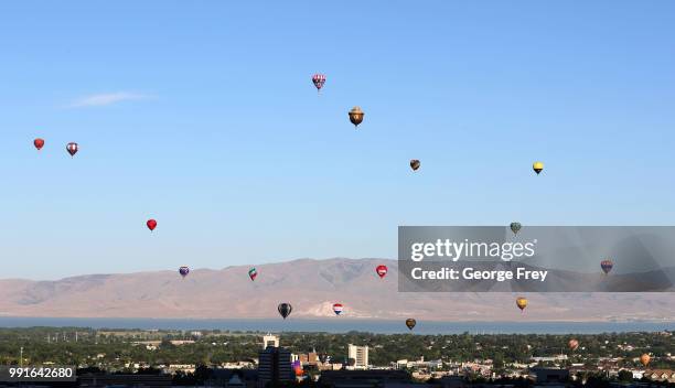 Many hot air balloons are launched at sunrise to kick off the Provo Freedom Festival Parade activities on July 4, 2018 in Provo, Utah. This is one of...