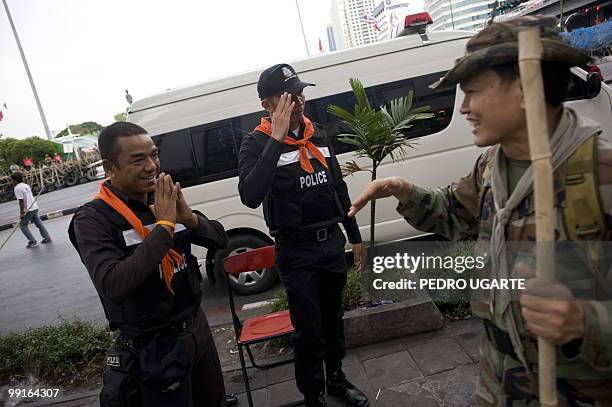 To go with profile story Thailand-politics-protest-SehDaeng by Patrick Falby In a picture taken on May 11 Thai policemen salute pro-red shirt...