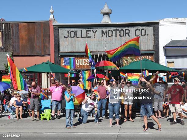 Support group cheers on a float from the group "Mormon Building Bridges" as it passes by as part of the Provo Freedom Festival Parade on July 4, 2018...