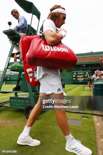 Stefanos Tsitsipas of Greece leaves the court as rain stops play during his Men's Singles second round match against Jared Donaldson of the United...