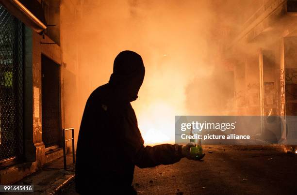 Demonstrator prepares to throw a Molotov cocktail during clashes with Greek Riot Police following a protest against state repression on the 44th...