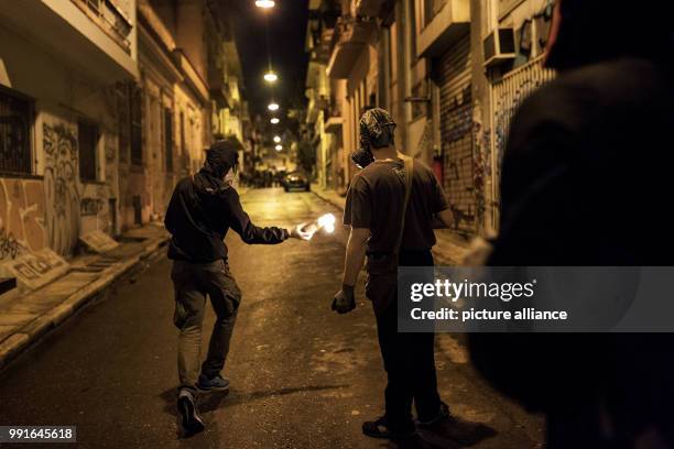 Demonstrator prepares to throw a Molotov cocktail during clashes with Greek Riot Police following a protest against state repression on the 44th...