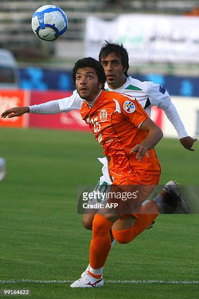 Zobahan's Esmail Farhadi approaches Mes Kerman's Mohammad Reza Torabi as he prepares to head the ball during their AFC Champions League round of 16...