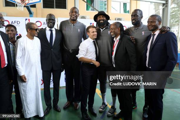 French President Emmanuel Macron and managing director of NBA Africa Amadou Gallo Fall pose for a picture with former pro NBA Africa basketball...