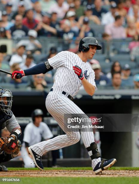 Greg Bird of the New York Yankees follows through on a second inning RBI single against the Atlanta Braves at Yankee Stadium on July 4, 2018 in the...