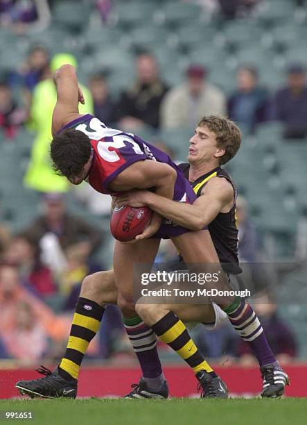 Ashley Prescott of Fremantle is tackled by Greg Tivendale of Richmond during round ten of the AFL season in the match between the Fremantle Dockers...