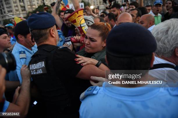 People protest in front of the Romanian Government headquarters in Bucharest July 4, 2018. - Romania's parliament voted through controversial changes...