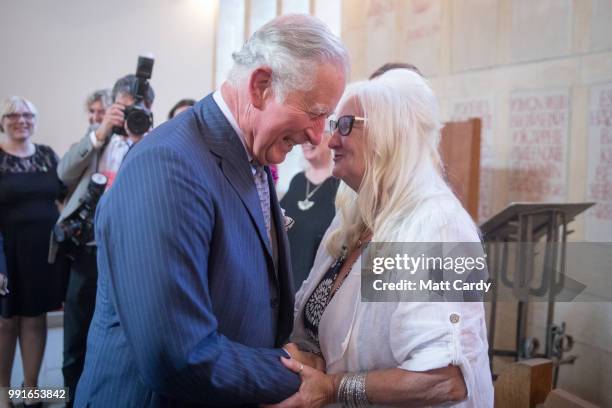 Prince Charles, Prince of Wales speaks with the first baby born on the NHS, Aneira Thomas, who is also a retired nurse, as he attends a thanksgiving...