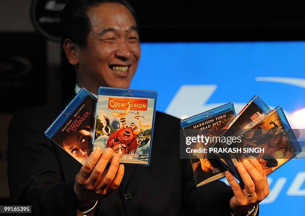 Managing Director of Sony India Masaru Tamagawa poses with Blu-ray discs of Hollywood movies during the launch of newly launch Blu-Ray Disc player BD...