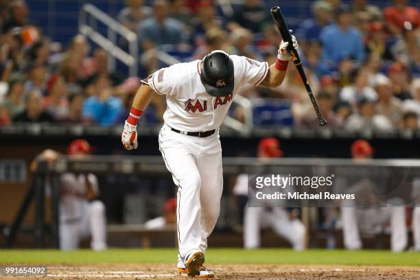Derek Dietrich of the Miami Marlins reacts after flying out to the outfield against the Tampa Bay Rays at Marlins Park on July 4, 2018 in Miami,...