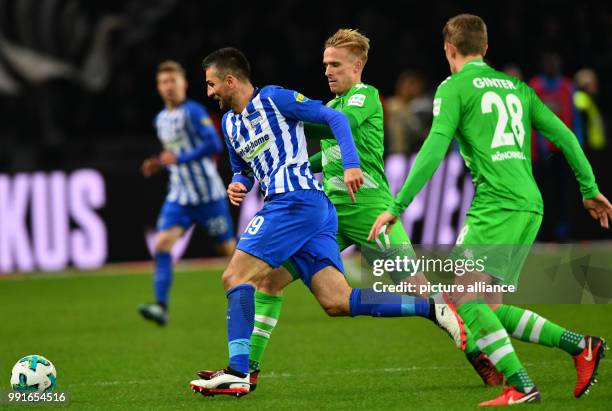 Berlin's Vedad Ibisevic in action against Moenchengladbach's Oscar Wendt and Matthias Ginter during the German Bundesliga soccer match between Hertha...