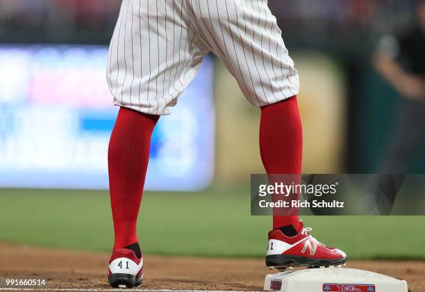 The baggy pants and knee high socks of Carlos Santana of the Philadelphia Phillies in action against the Washington Nationals during a game at...