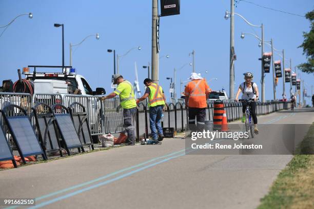 City workers install permanent barriers along Martin Goodman Trail where 5-year-old cyclist Xavier Morgan died last year after falling into live lane...