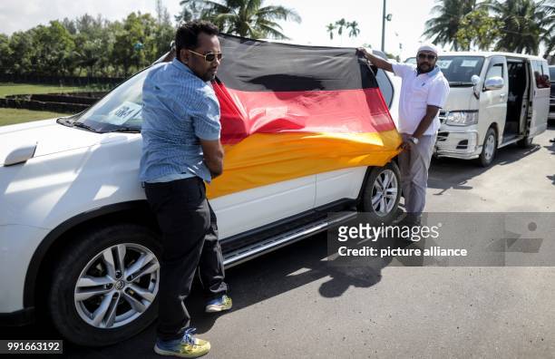 Two drivers holding a German flag for Foreign Minister Sigmar Gabriel near the refugee camp in Kutupalong, Bangladesh, 19 November 2017. German...