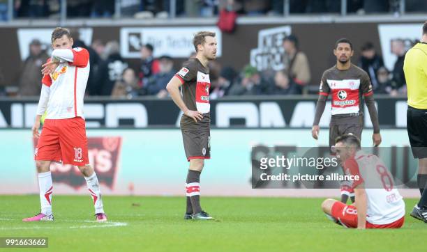 Regensburg's Marc Lais , Hamburg's Christopher Buchtmann, Jeremy Dudziak and Regensburg's Andreas Geipl standing on the pitch after the 2nd...